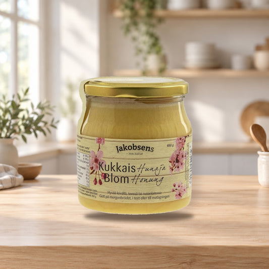 Jakobsens Flower Honey 650g – product photo on a table